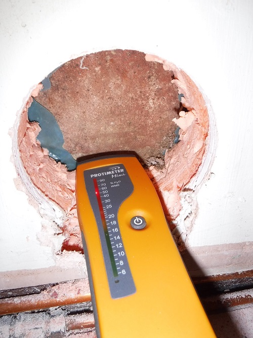 Uncovering damp wall behind existing XPS insulation in a phased retrofit of an 1800s sandstone detached house near Preston
