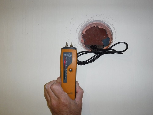 Uncovering damp wall behind existing XPS insulation in a phased retrofit of an 1800s sandstone detached house near Preston