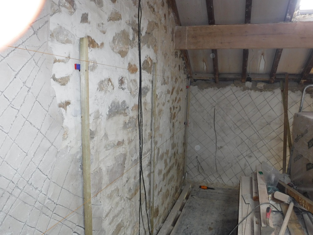 Dubbing out walls prior to diathonite for a phased retrofit of an 1800s sandstone detached house near Preston